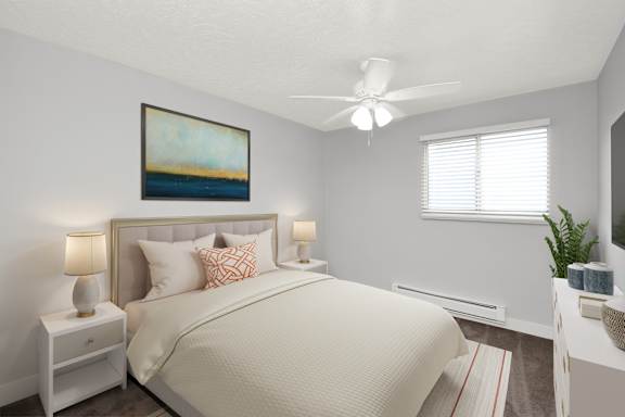 Floor Plan  A bedroom with a large bed, a ceiling fan, and a painting on the wall.