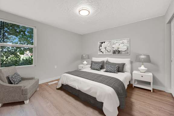 Floor Plan  A bedroom with a bed, nightstand, and chair.