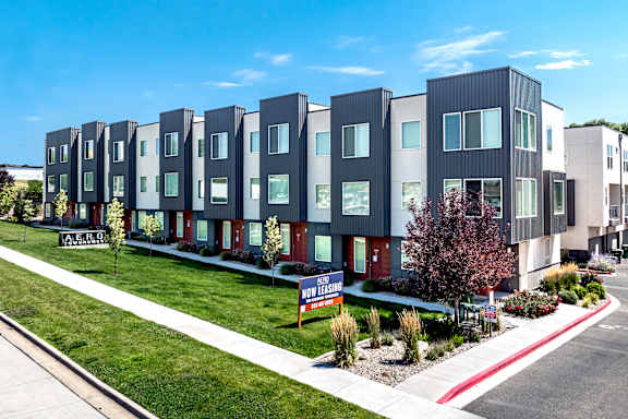 Apartment complex with a sign that says "Now Leasing".