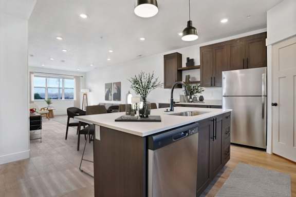 A modern kitchen with a large island and stainless steel appliances.
