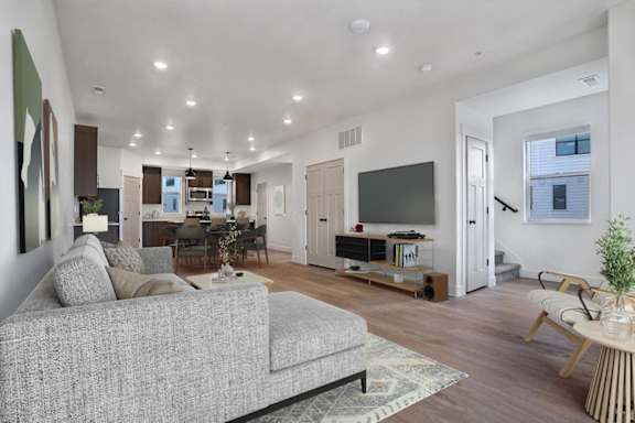 A living room with a grey couch and a television.