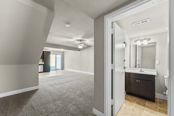 A bathroom with a sink, mirror, and toilet is shown.
