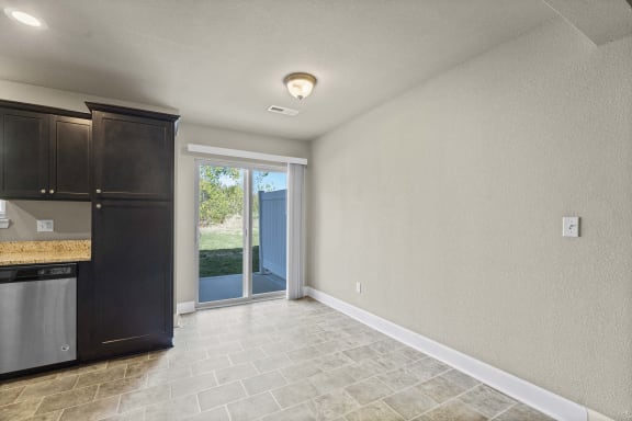 the kitchen is open to the living room and the backdoor to the patio