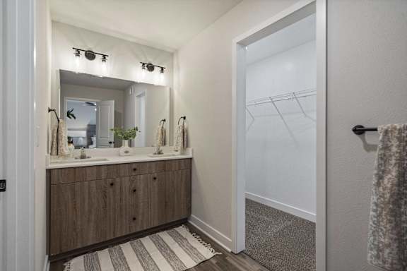 A bathroom with a vanity and a mirror.