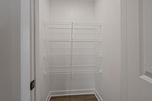 Empty white shelves in a white room.