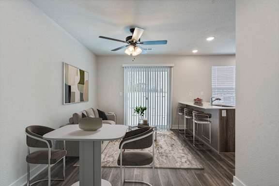 A modern dining room with a white table and chairs.
