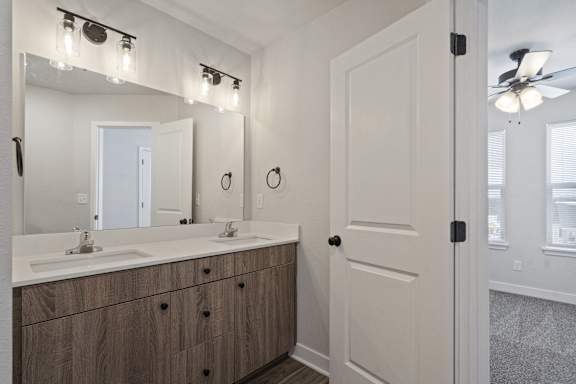 A bathroom with a vanity and a mirror.