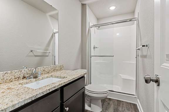 A bathroom with a sink, toilet, and shower.