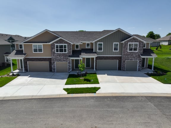 a two story house with a garage and a driveway