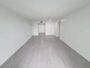 A long white hallway with a light at the end.