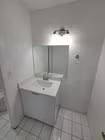 A white sink in a small bathroom.