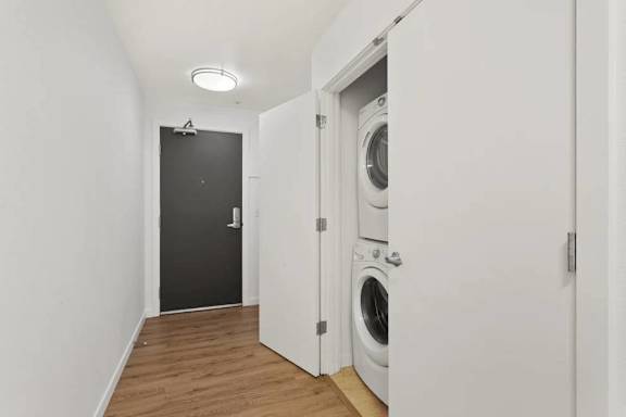 A laundry room with a washer and dryer built into the wall.