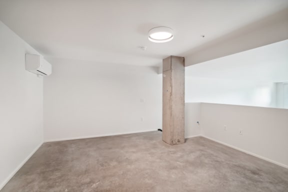 a empty room with a column in the middle of it at Analog PDX Apartments, Oregon 97227