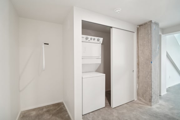 a white laundry room with a washer and dryer in it at Analog PDX Apartments, Oregon 97227