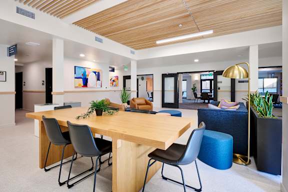 A conference room with a long table and chairs.