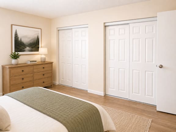 Bedroom with sliding closet doors and natural wood floors at Laurel on 2nd Apartments, Newberg, Oregon