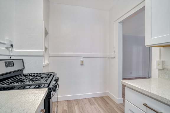 Floor Plan  A kitchen with a stove top oven and a counter top.