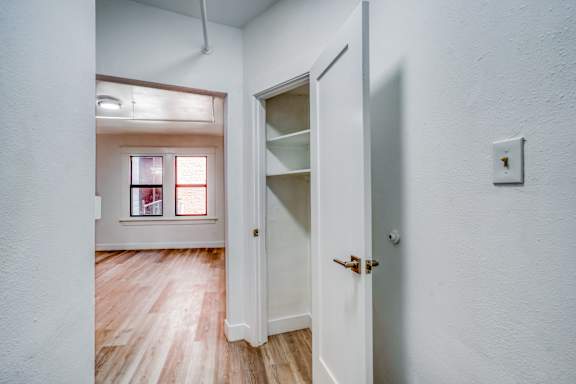 A white door with a shelf and a light switch on the wall at Clay & Tiffany, Portland, 97201