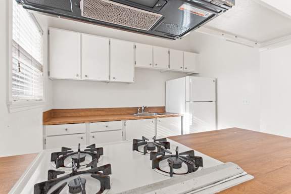 Kitchen with a white stove at Garden Villa Apartments, Portland, OR