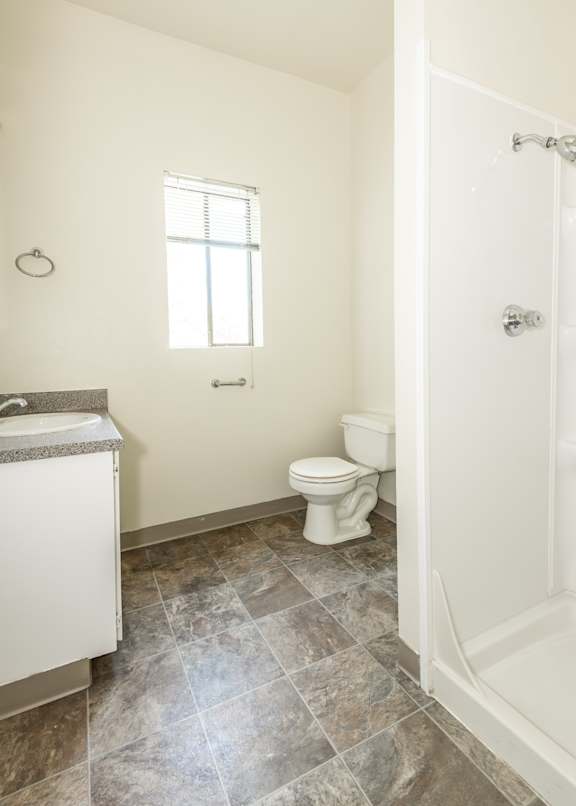 A bathroom with a toilet, sink, and tub.