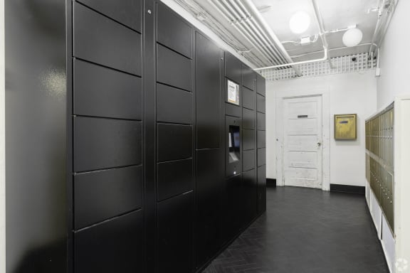 a row of black lockers in a room with a door at Clay & Tiffany, Portland, 97201