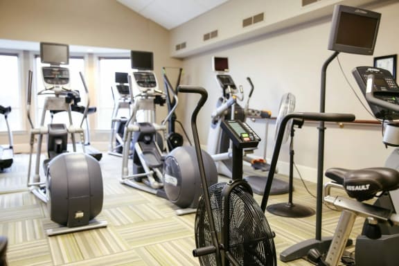 a gym with various exercise equipment in a room at Schaefer Ridge Apartments, Branson