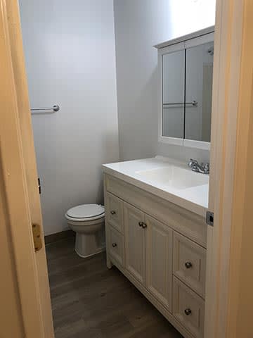 a bathroom with a toilet sink and mirror