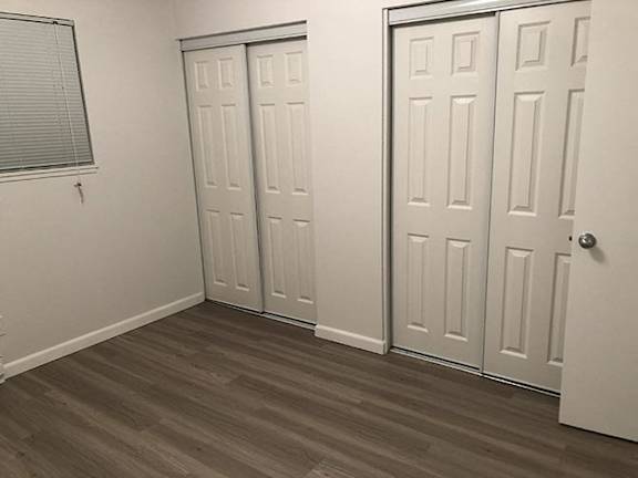 a room with three doors and a window
