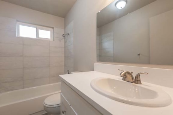 a bathroom with a sink toilet and bathtub