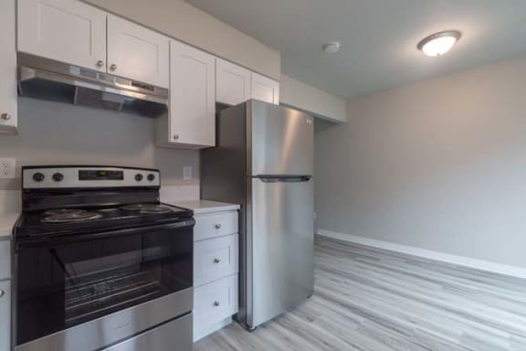 a kitchen with a stove and a refrigerator