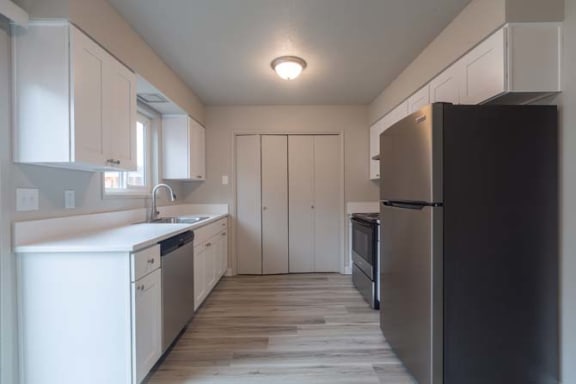 a kitchen with a refrigerator a sink and a stove