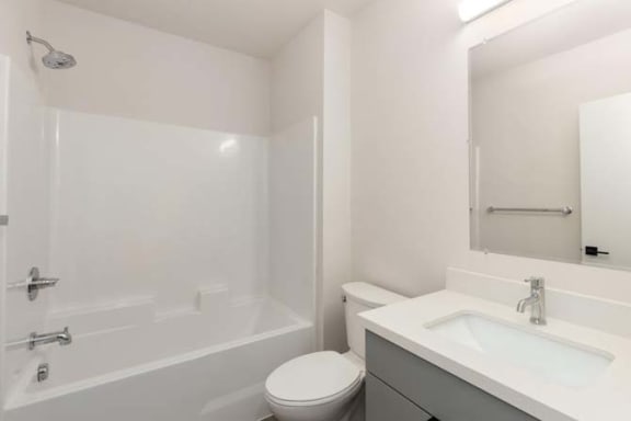 a bathroom with a toilet sink and bathtub