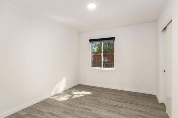 a room with a window and a wooden floor
