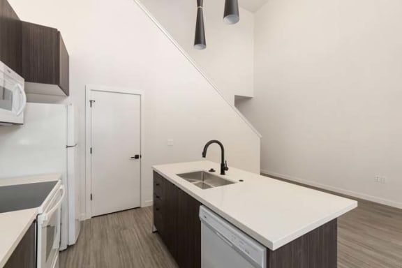 a kitchen with a sink a stove and a refrigerator