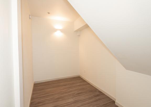 A hallway with wooden floors and white walls at Society 62 Apartments, Portland