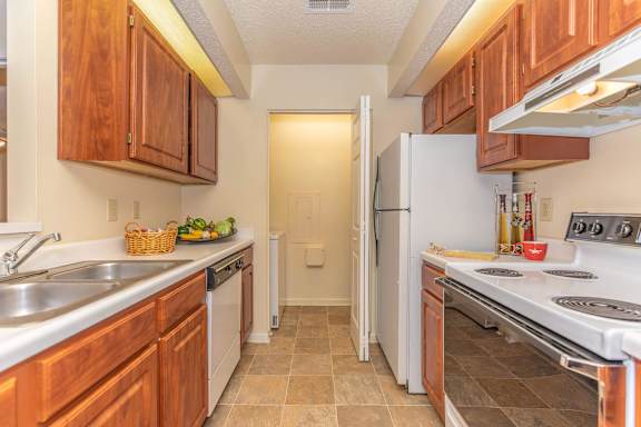 a kitchen with wood cabinets and white appliances