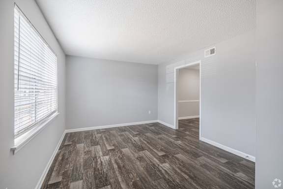 A room with a window and wooden flooring.at Brandywine Townhomes, Goose Creek South Carolina