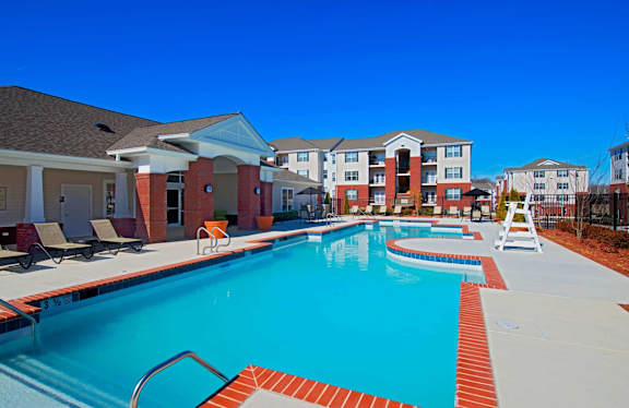 A swimming pool surrounded by a red brick border.