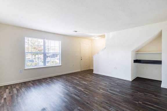 A room with wooden floors and a window.at Crescent Pointe Townhomes, Stafford Virginia