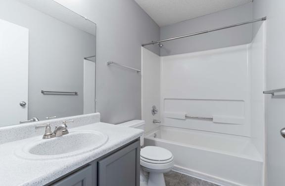 A white bathroom with a toilet, sink, and bathtub.at Jamestown Pointe Apartments, Greenville, SC