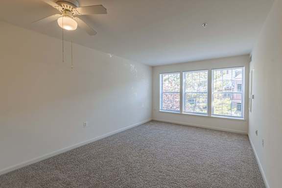 A room with a ceiling fan and carpeted floor at Kendrick Court, Herndon, 20171