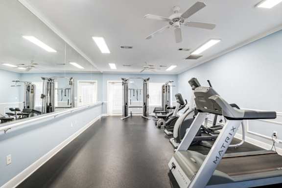 A gym with a treadmill and other exercise equipment at The Regency Apartment Homes/Broad Pointe, Manassas, 20109