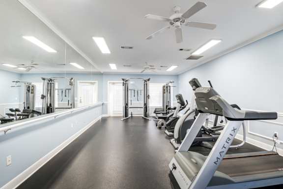 A gym with a treadmill and other exercise equipment at The Regency Apartment Homes, Manassas, VA