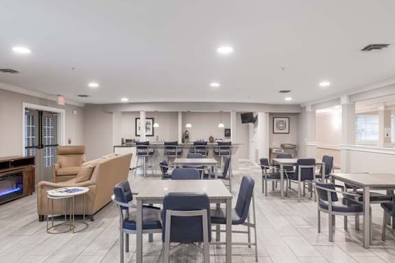 A spacious dining area with tables and chairs.