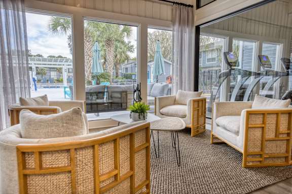 a living room filled with furniture and a large window at Dwell at Greenridge, North Charleston, SC, 29406