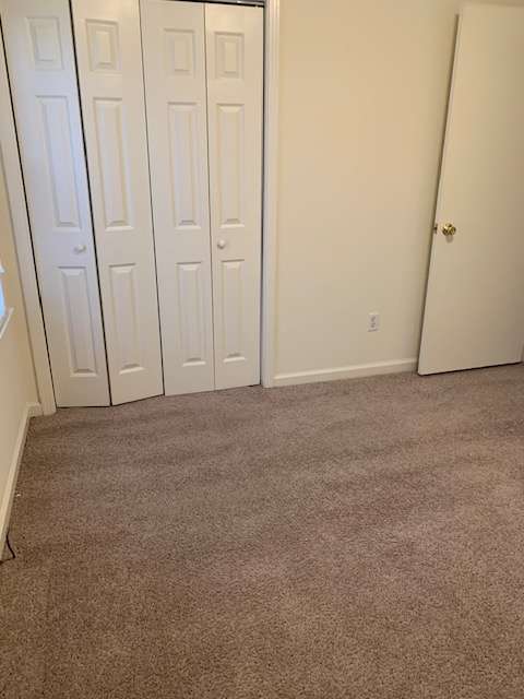 A white cabinet with a brown wall behind it.