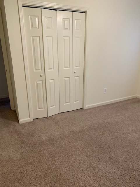 A white ventilation grill is on a beige wall.