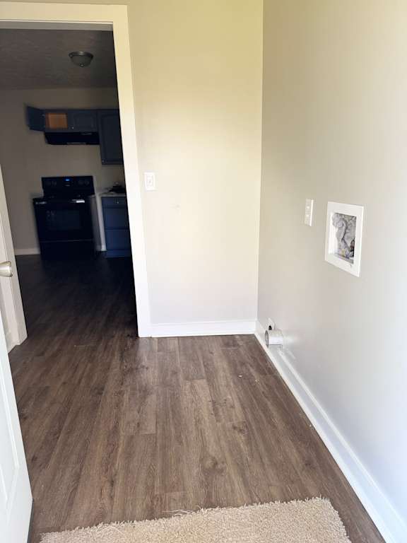 A hallway with a white rug on the floor.