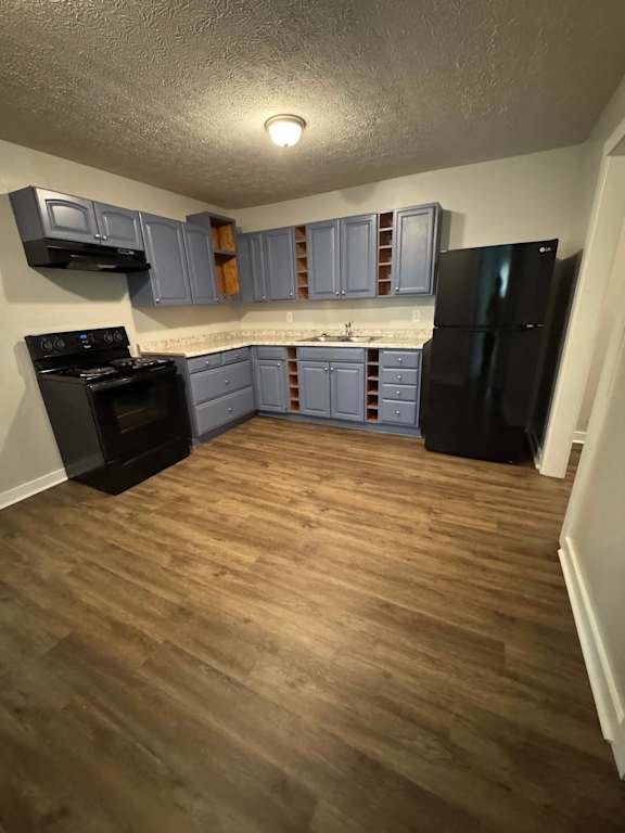 A room with a wooden wall and a black television.