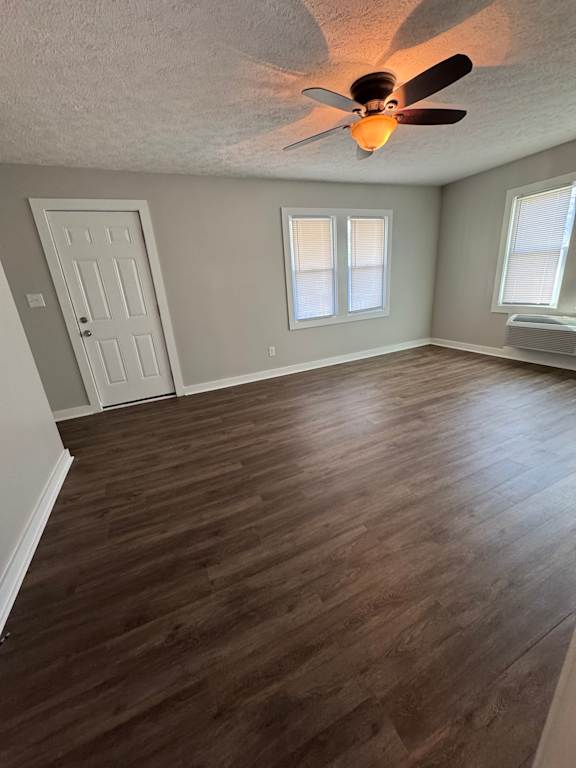 A room with a ceiling fan and a window.